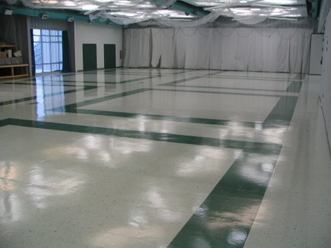Community hall floor after strip and wax, high gloss finish